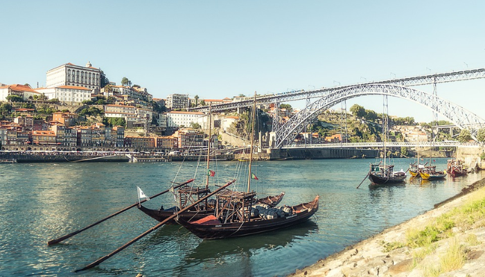 Viajar para Portugal é muito mais do que um destino turístico; é uma viagem ao coração da cultura, história e beleza natural. Ao pisar em solo português, você se vê imerso em uma terra onde o passado e o presente se entrelaçam de forma harmoniosa. Das ruas de pedra de Lisboa, onde o fado ecoa em cada esquina, às praias deslumbrantes da Nazaré, onde as ondas gigantes desafiam surfistas do mundo todo, Portugal oferece uma experiência única para cada tipo de viajante.

Cada cidade portuguesa conta uma história. Em Porto, o aroma do vinho homônimo que envelhece nas caves ao longo do Rio Douro convida você a uma degustação que transcende o paladar, revelando séculos de tradição. Em Sintra, os palácios de contos de fadas e os jardins exuberantes parecem saídos de um sonho, evocando uma época de realeza e mistério. Já no Alentejo, a tranquilidade das planícies douradas convida à introspecção, oferecendo uma pausa revigorante da agitação do dia a dia.

Portugal é também um paraíso para os amantes da gastronomia. Saborear um pastel de nata fresquinho em uma pastelaria de Lisboa, degustar frutos do mar preparados com perfeição em uma taverna à beira-mar no Algarve, ou brindar com um vinho verde em uma adega familiar são experiências que vão muito além de uma simples refeição. É uma conexão com as raízes de um povo que valoriza o sabor e a qualidade em cada prato.

Mas o verdadeiro encanto de Portugal está nas pessoas. A hospitalidade calorosa dos portugueses faz com que você se sinta em casa, seja em uma pequena vila rural ou em um animado bairro urbano. Eles compartilham com orgulho suas tradições, histórias e segredos locais, garantindo que sua viagem seja enriquecida com momentos autênticos e inesquecíveis.

Viajar para Portugal não é apenas visitar monumentos ou paisagens deslumbrantes; é uma jornada que toca a alma, onde cada experiência é uma oportunidade de se conectar com algo mais profundo. É um país que encanta, inspira e deixa uma marca duradoura em todos que o exploram. Ao partir, você não estará simplesmente indo embora; estará levando consigo um pedaço de Portugal no coração.